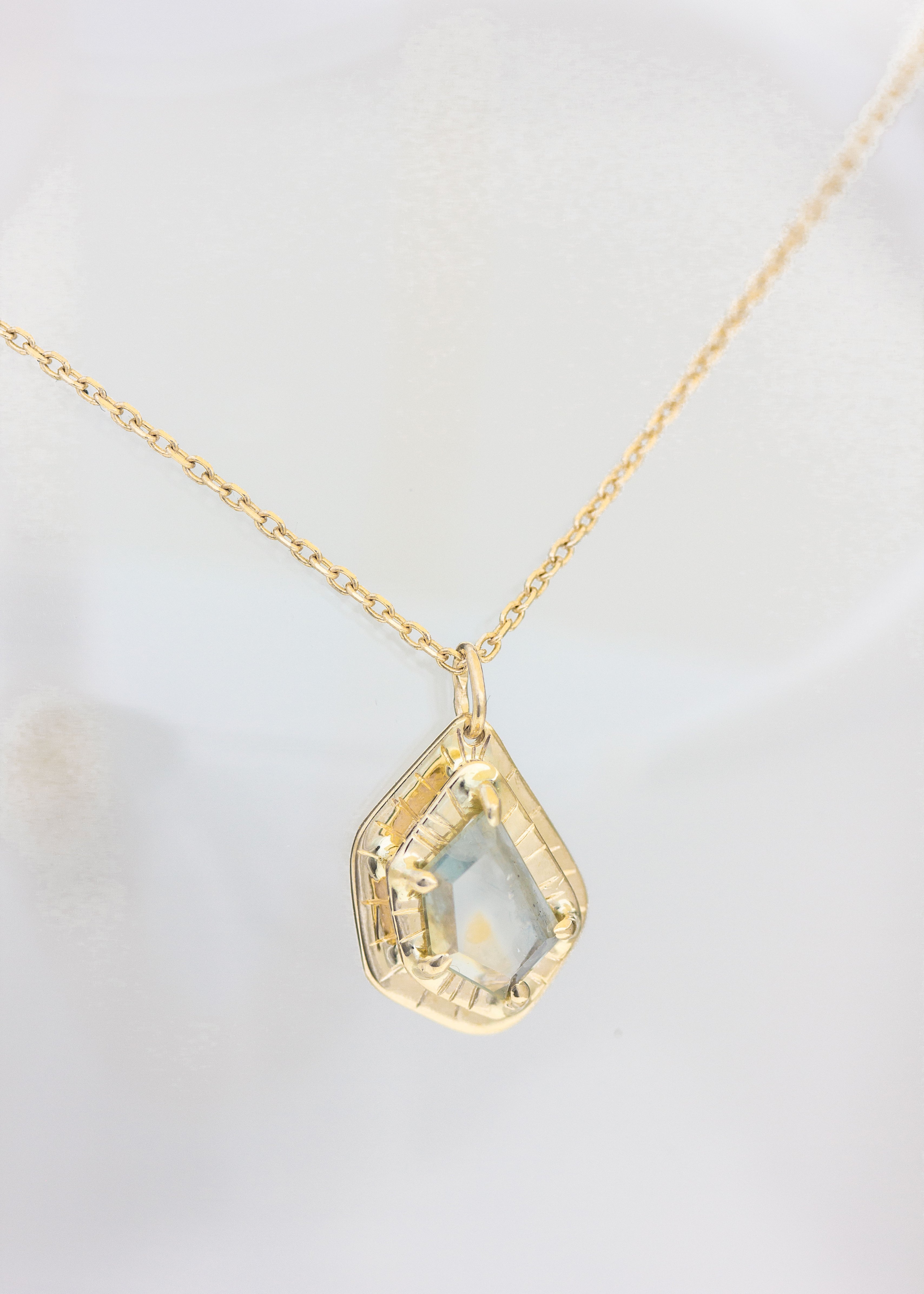 Custom bridal necklace in 14k yellow gold set with a ooak Montana sapphire spice. 
